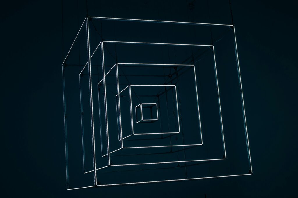 Dynamic abstract design with glowing neon cubes creating depth and perspective.